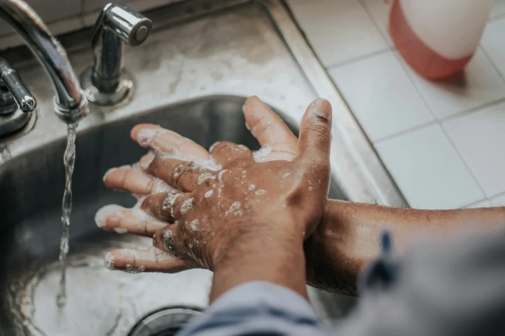 Lavado de manos con jabón en el fregadero.